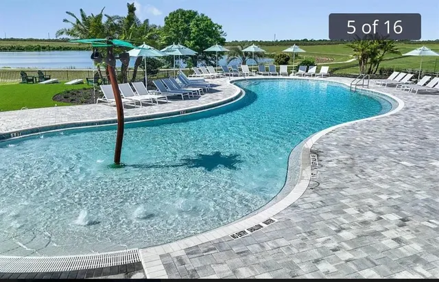 a view of a swimming pool with a lounge chairs