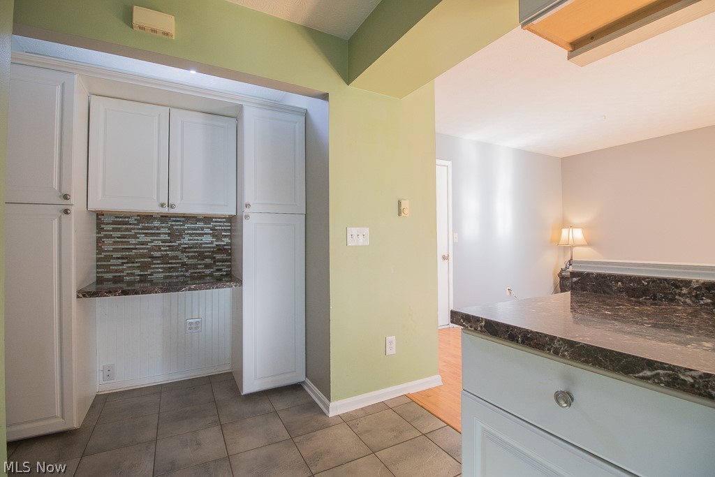 2744 Haines Road Madison, OH 44057 - Photo 19 of 26 Kitchen with, white cabinetry, tasteful backsplash, and light tile patterned floors