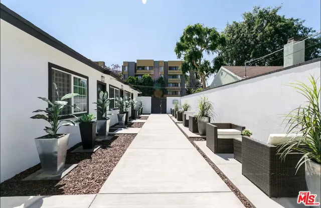 a view of a house with backyard and sitting area