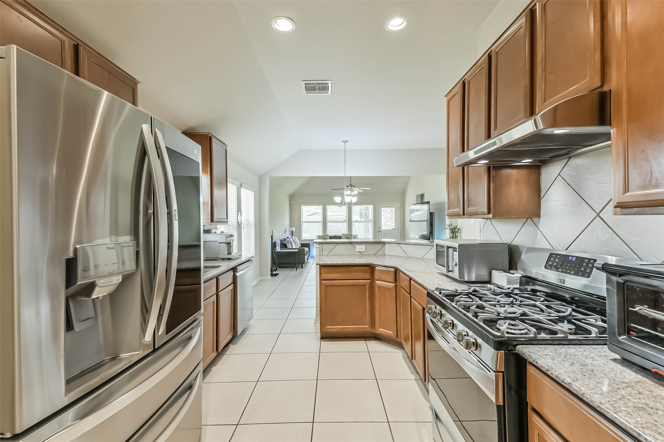 2504 Elm Crossing Trail Spring, TX 77386 - Photo 6 of 40 a kitchen with stainless steel appliances granite countertop a refrigerator a stove and a sink