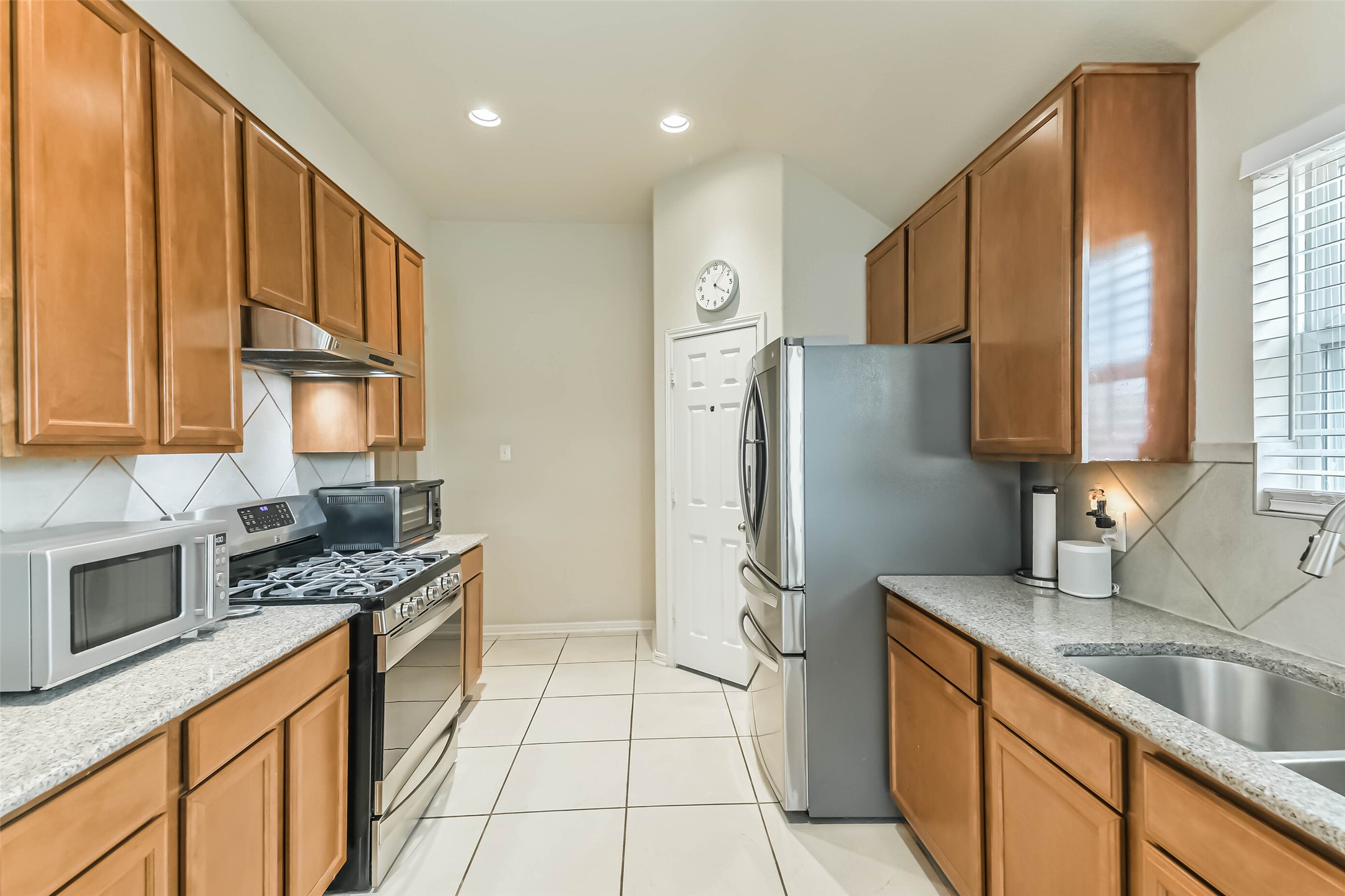 2504 Elm Crossing Trail Spring, TX 77386 - Photo 9 of 40 a kitchen with stainless steel appliances granite countertop a refrigerator and a sink