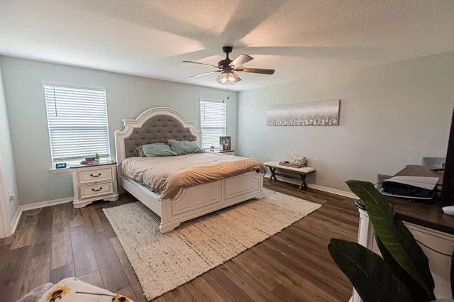 a bedroom with a bed and a chandelier