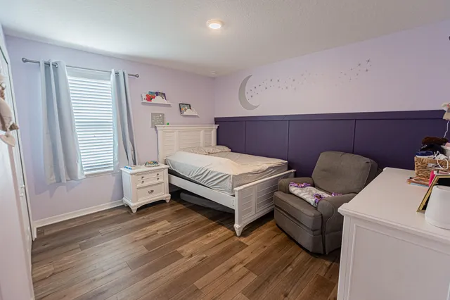 a bedroom with a bed and a dresser