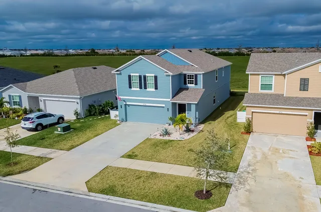 an aerial view of a house with a yard