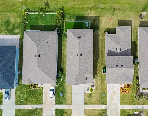 an aerial view of a house with a yard