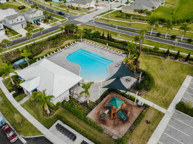 an aerial view of a house with a yard basket ball court and outdoor seating