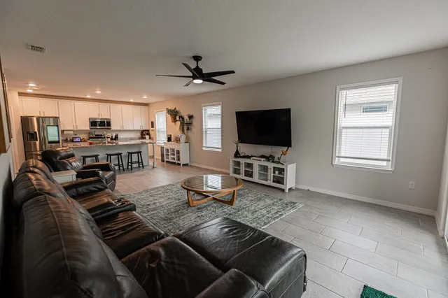 a living room with furniture and a flat screen tv