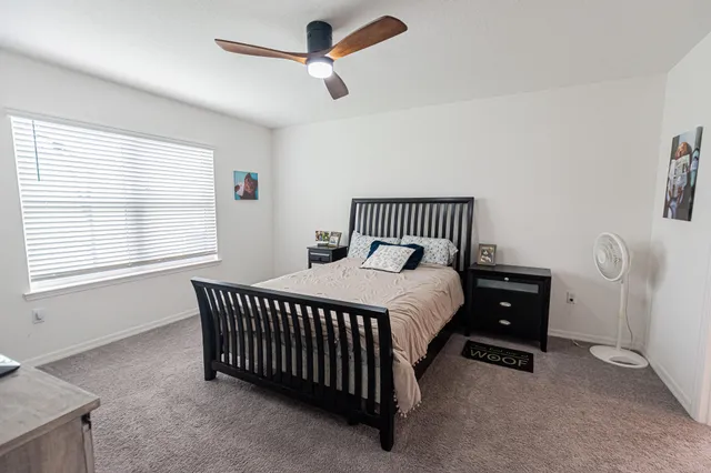 a bedroom with a bed and window