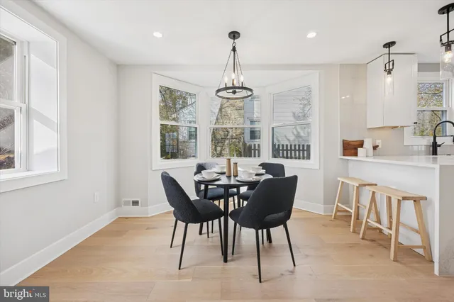 a view of a dining room with furniture wooden floor and chandelier