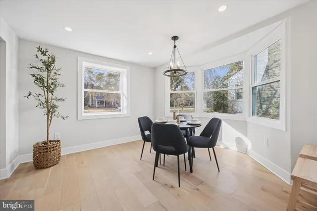 a spacious en suite bathroom with a double vanity sink a mirror a and a window