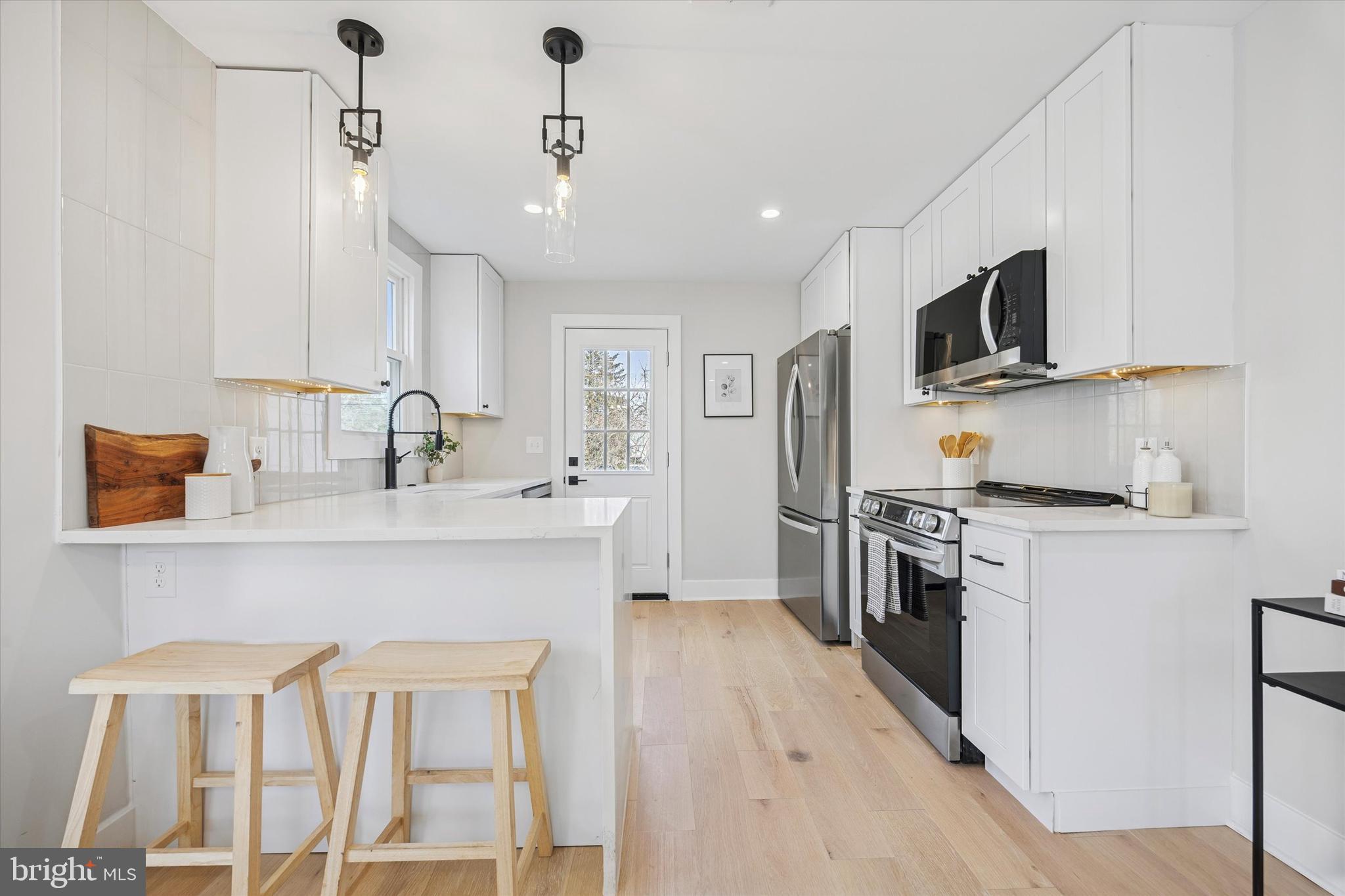 219 Williamsburg Road Ardmore, PA 19003 - Photo 20 of 75 a kitchen with stainless steel appliances a sink stove and microwave