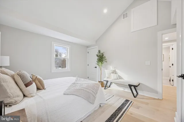 a bedroom with a bed and a lamp