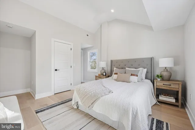 a bedroom with a bed and painting on the wall