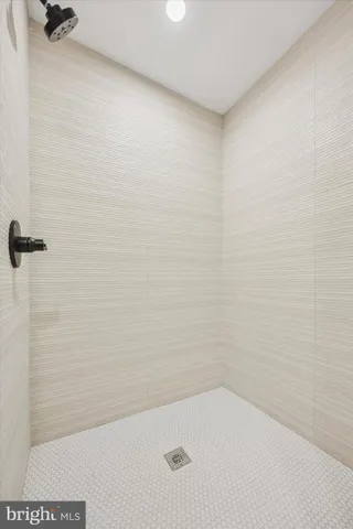 a bedroom with a large bed and a wooden floor