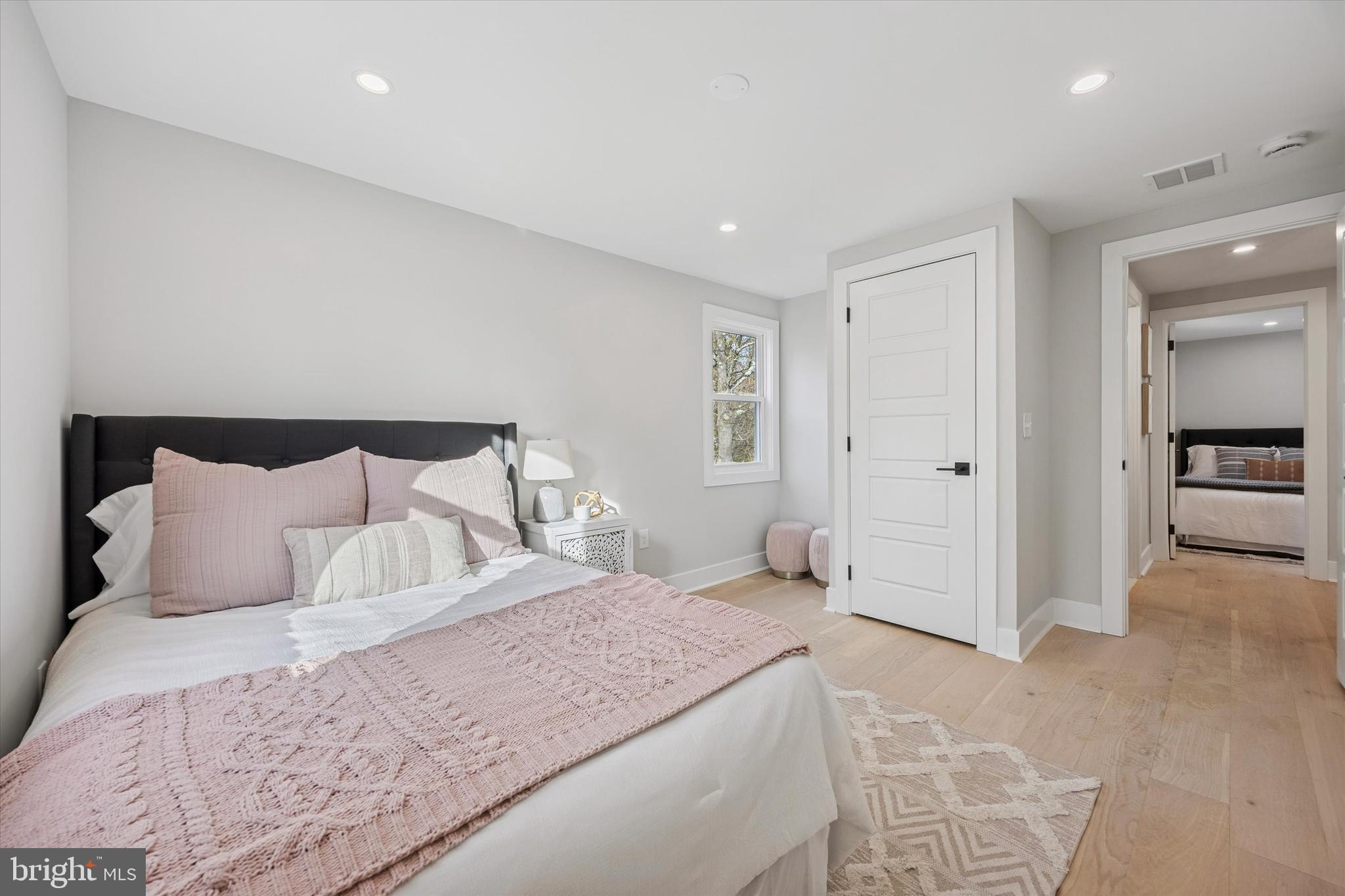 219 Williamsburg Road Ardmore, PA 19003 - Photo 42 of 75 a bedroom with a bed and a lamp