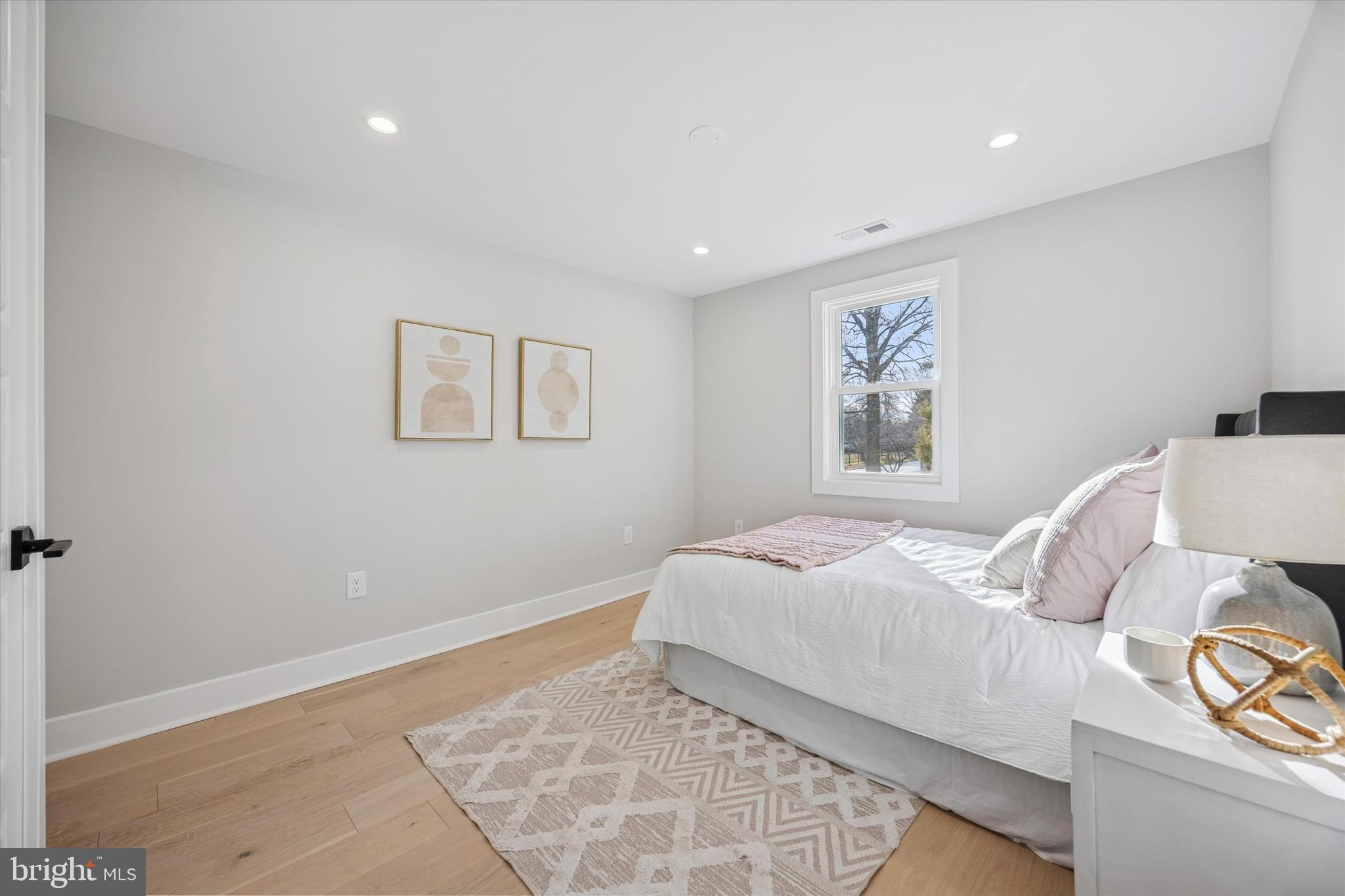 219 Williamsburg Road Ardmore, PA 19003 - Photo 43 of 75 a bedroom with a bed and painting on the wall