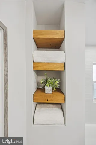 a front view of a house with a tree