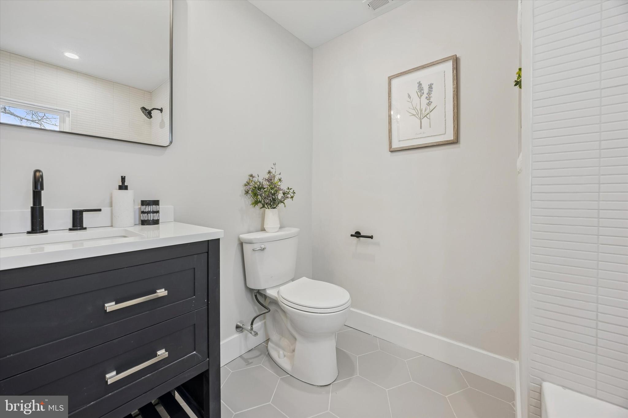219 Williamsburg Road Ardmore, PA 19003 - Photo 54 of 75 a bathroom with a toilet sink and mirror
