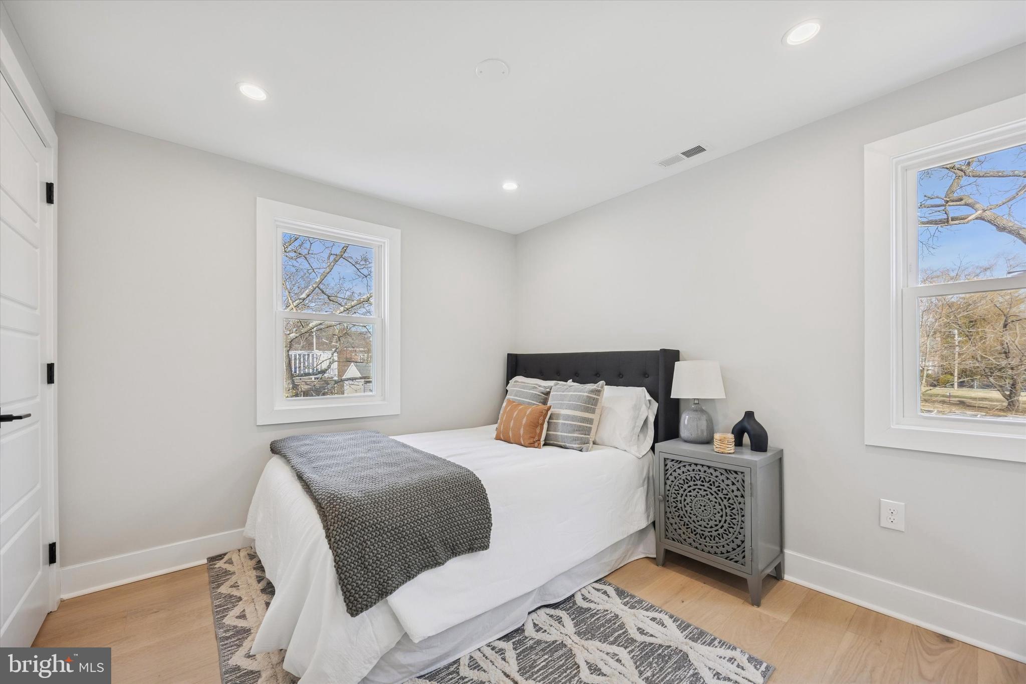219 Williamsburg Road Ardmore, PA 19003 - Photo 55 of 75 a bedroom with a bed and a painting on the wall
