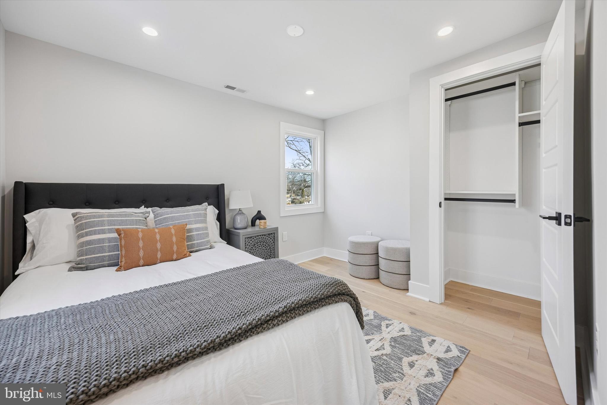 219 Williamsburg Road Ardmore, PA 19003 - Photo 56 of 75 a bedroom with a large bed and a wooden floor