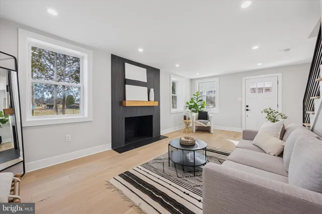 a living room with a fireplace and a table