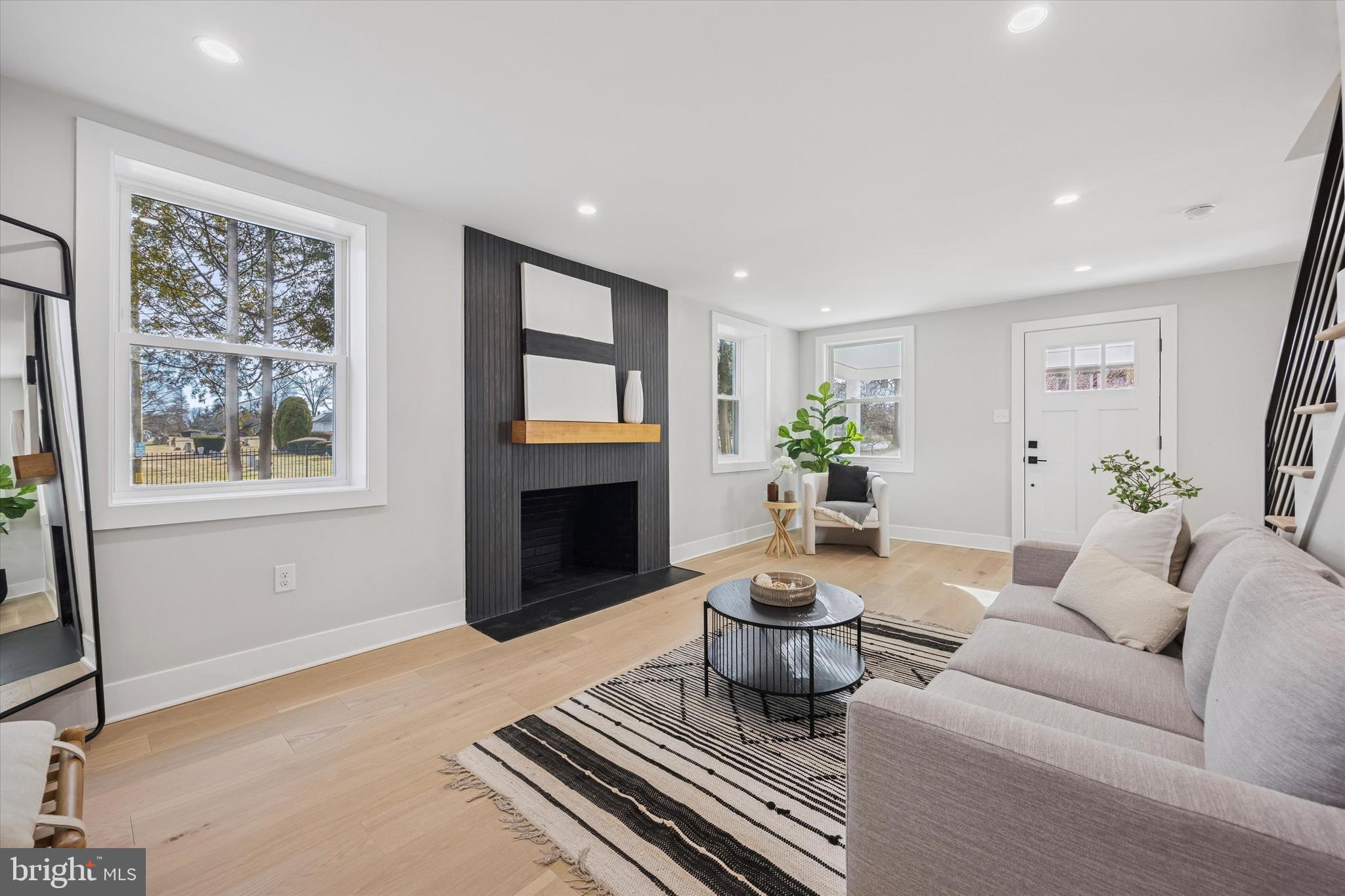 219 Williamsburg Road Ardmore, PA 19003 - Photo 10 of 75 a living room with furniture a fireplace and a window