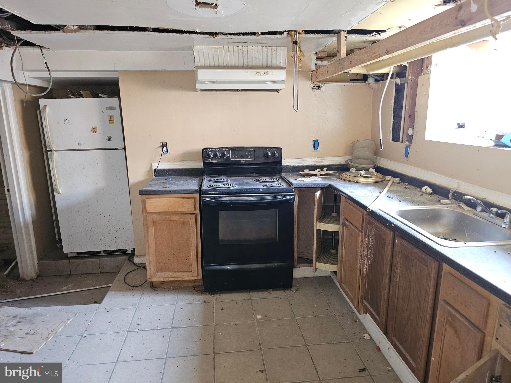 3514 Bank Street Baltimore, MD 21224 - Photo 64 of 71 a kitchen with a stove top oven and refrigerator