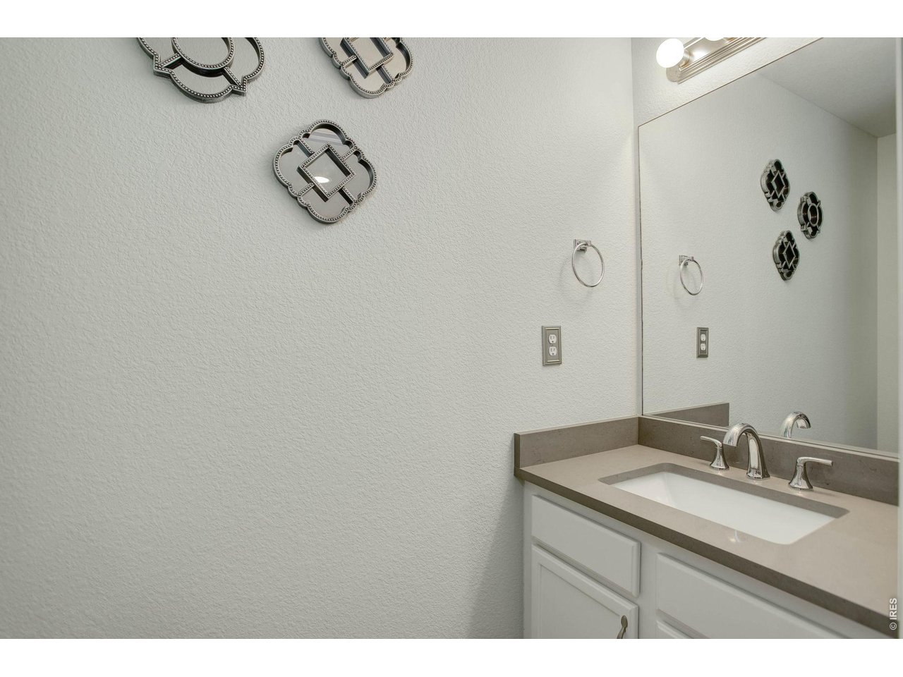 4116 Riley Drive Longmont, CO 80503 - Photo 18 of 33 Convenient half bath on main level with updated quartz countertop