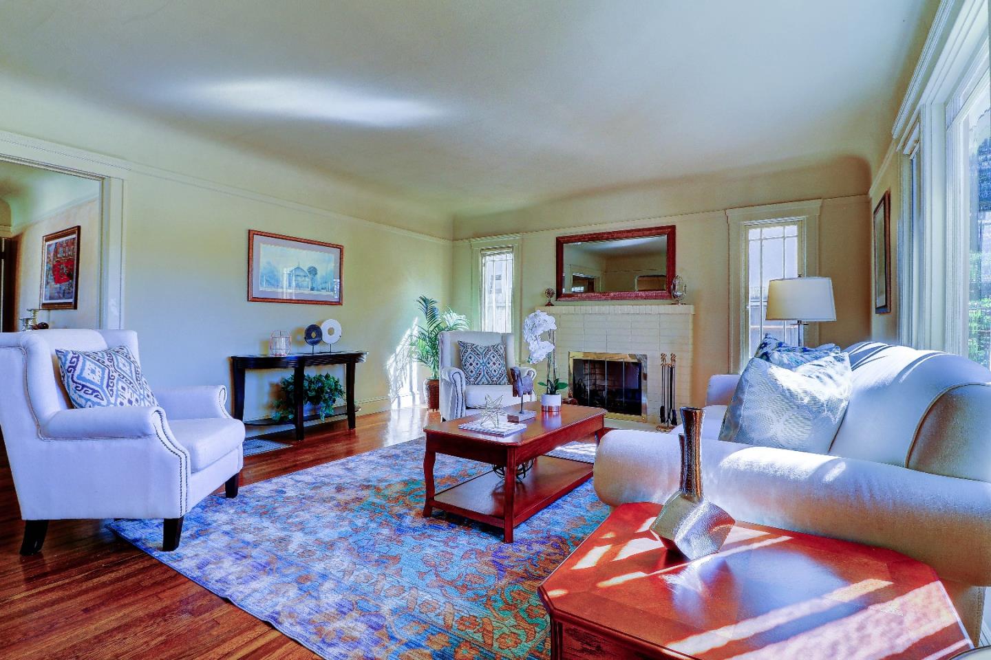 2701 Hillside Drive Burlingame, CA 94010 - Photo 12 of 50 a living room with furniture a rug and a fireplace