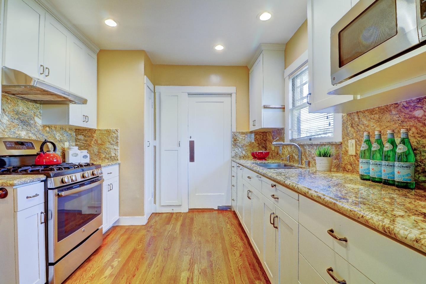 2701 Hillside Drive Burlingame, CA 94010 - Photo 18 of 50 a kitchen with stainless steel appliances granite countertop a refrigerator and a stove top oven