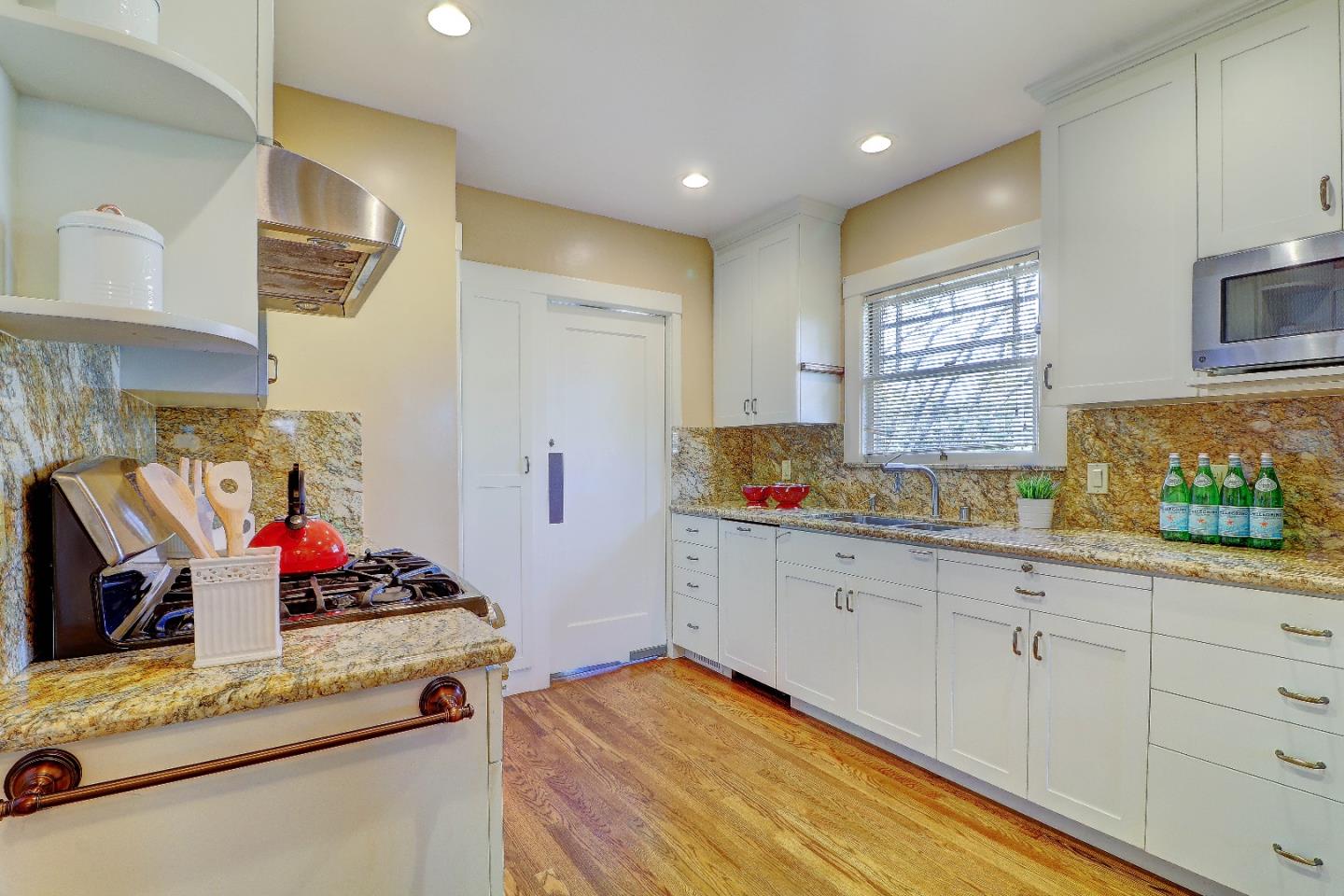2701 Hillside Drive Burlingame, CA 94010 - Photo 19 of 50 a kitchen with granite countertop cabinets stainless steel appliances and sink