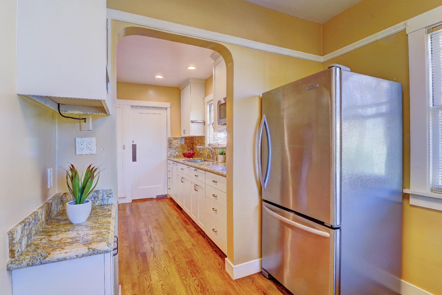 2701 Hillside Drive Burlingame, CA 94010 - Photo 20 of 50 a kitchen with stainless steel appliances granite countertop a refrigerator and a counter top space