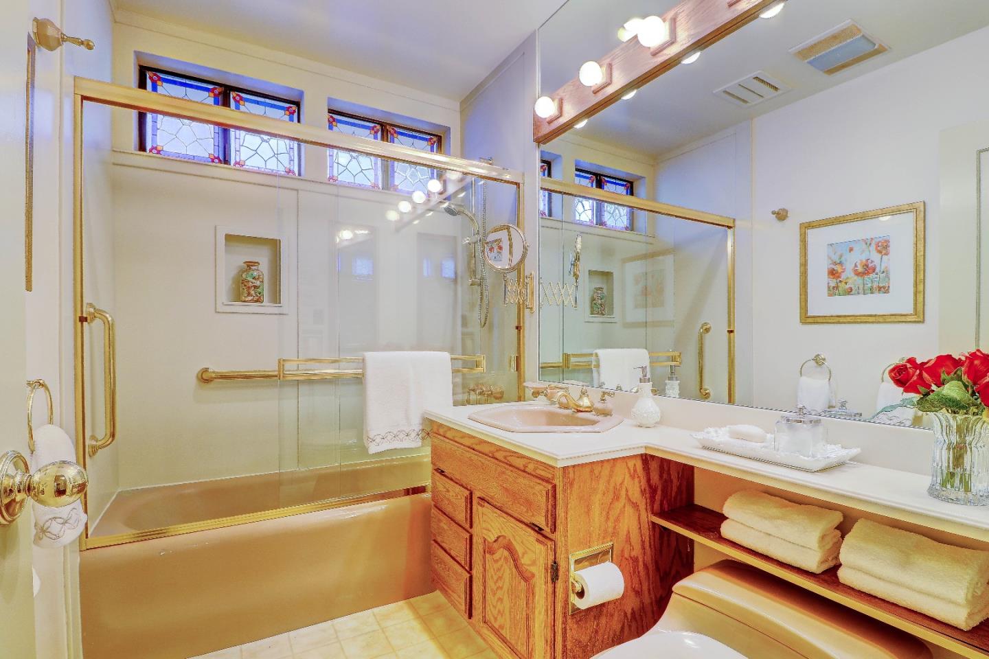 2701 Hillside Drive Burlingame, CA 94010 - Photo 23 of 50 a bathroom with a sink a large mirror and a bathtub