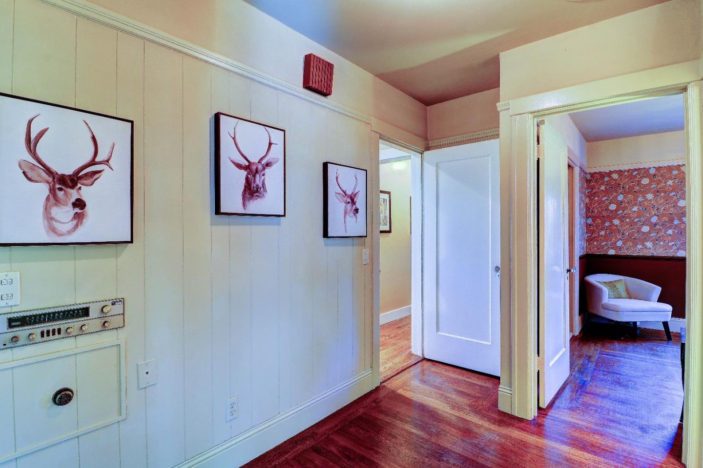 2701 Hillside Drive Burlingame, CA 94010 - Photo 24 of 50 a view of a hallway with wooden floor and furniture
