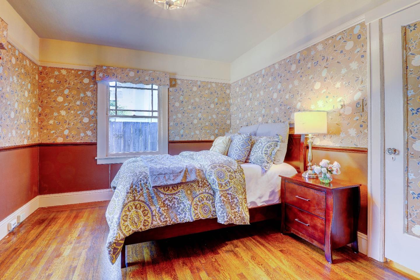 2701 Hillside Drive Burlingame, CA 94010 - Photo 28 of 50 a bedroom with a bed and wooden floor