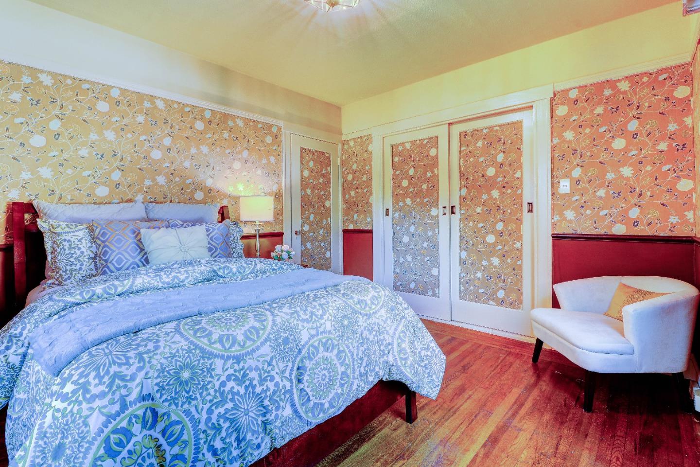 2701 Hillside Drive Burlingame, CA 94010 - Photo 29 of 50 a bedroom with a large bed and a wooden floor