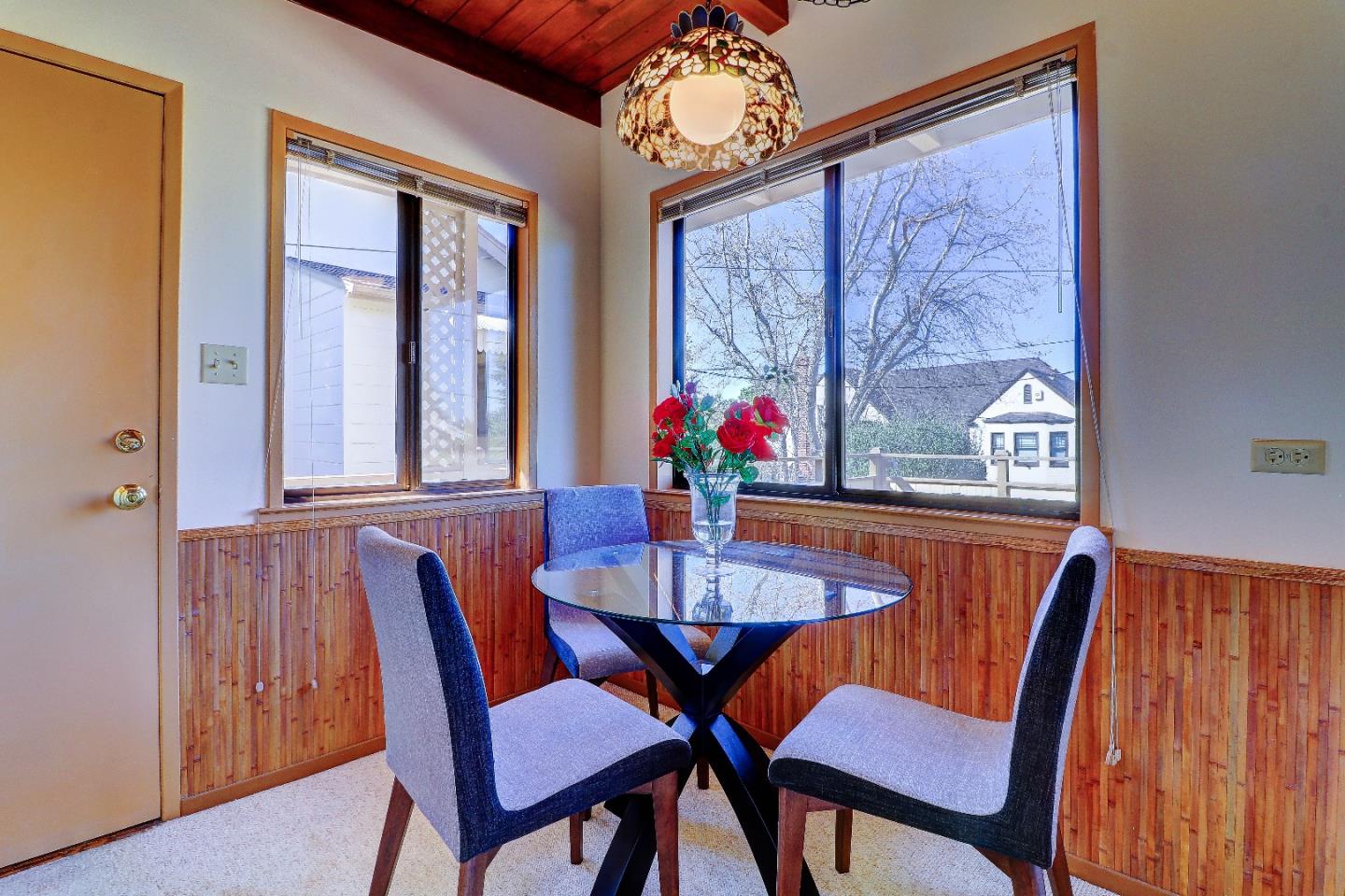 2701 Hillside Drive Burlingame, CA 94010 - Photo 35 of 50 a view of a dining room with furniture a chandelier and wooden floor