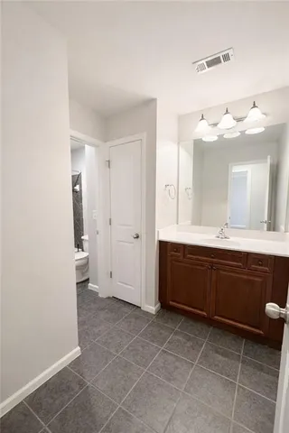 a spacious bathroom with a vanity a sink a mirror and a bathtub