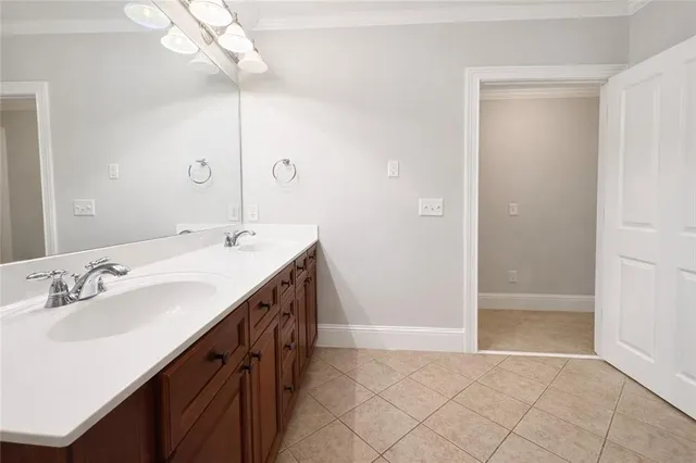 a spacious bathroom with a double vanity sink a mirror and a shower
