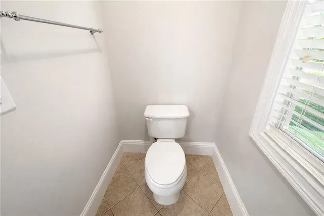 a bathroom with a toilet and a large window