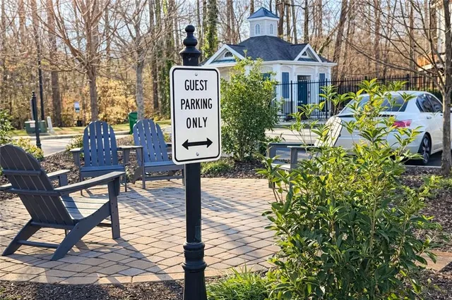 a sign board with a small yard and plants