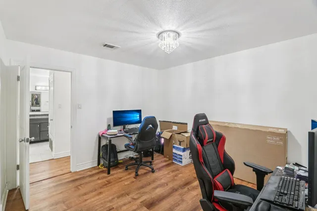 a view of a workspace with furniture and a window