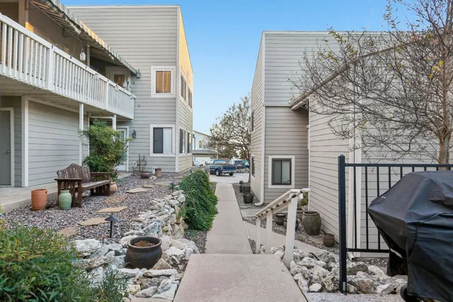 a view of a patio with couches chairs and potted plants