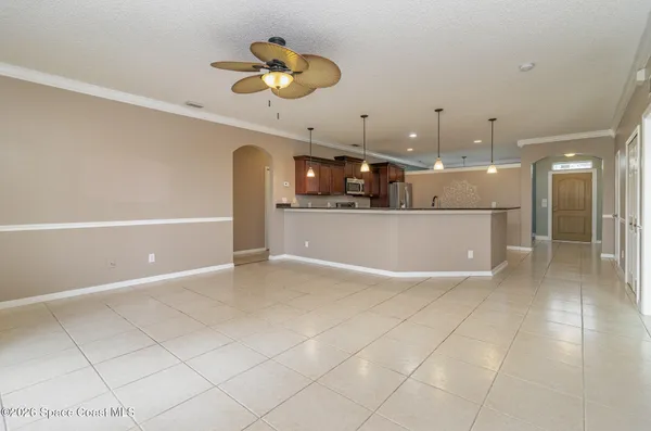 a view of a kitchen with a sink and chandelier