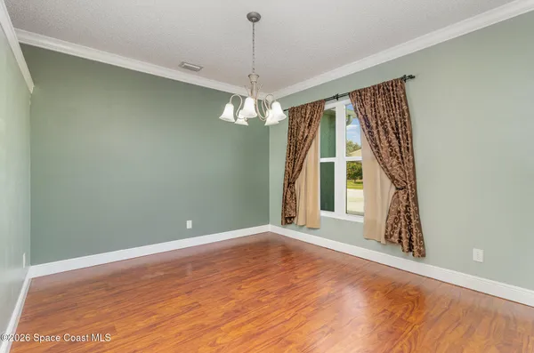 an empty room with windows and outdoor view