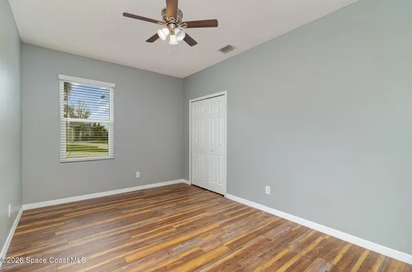 a view of a room with wooden floor and windows