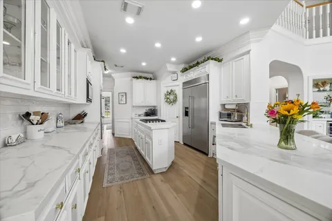 a kitchen with refrigerator and cabinets