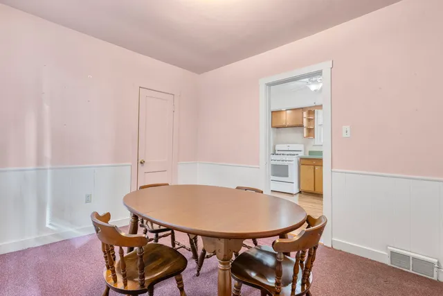 a view of a dining room with furniture and a window