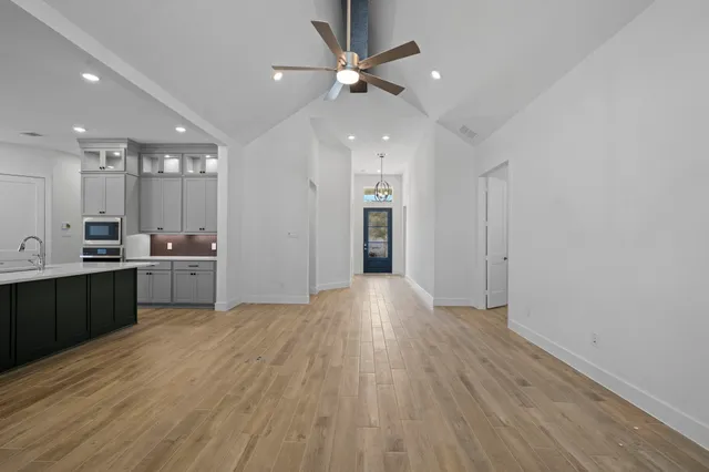 a view of a kitchen with a sink and a refrigerator