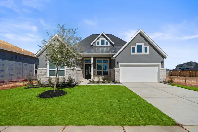 a front view of a house with a yard and porch